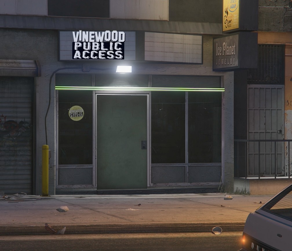 Vinewood Public Access storefront at night — Los Santos